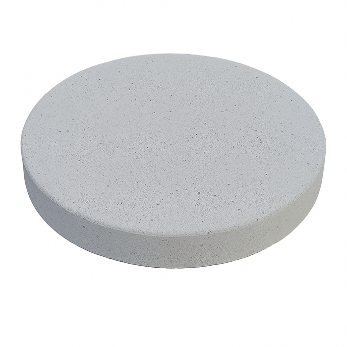 Granada White 18 inch round concrete stepping stone used in a modern garden path with green grass and flowers