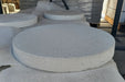 Close-up of Granada White round concrete stepping stone showing smooth Veranostone finish on white background
