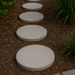 18 inch round white concrete paver installed as a garden walkway stone in residential landscaping